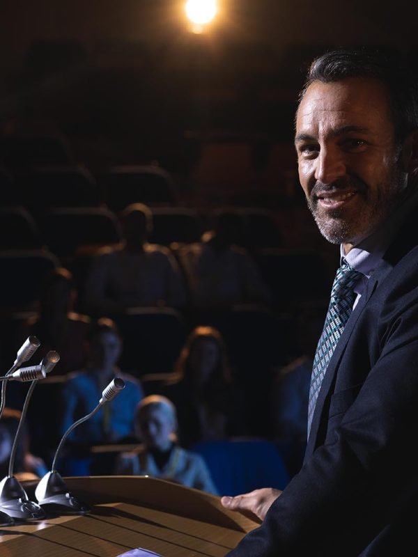 Front view of Caucasian businessman standing for presentation and looking at camera
